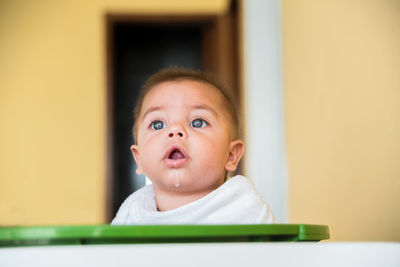 Close-up of baby boy in container at home