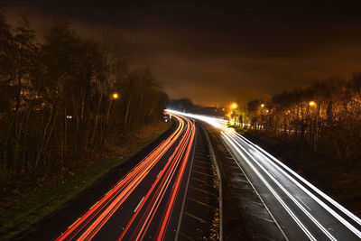 High angle view of light trails on road at night