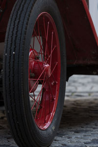 Close-up of red wheel on field