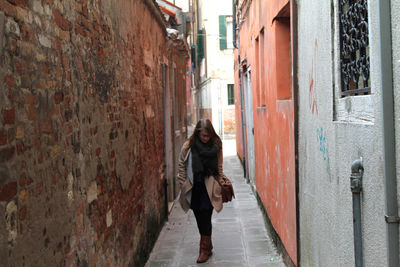 Woman walking on alley