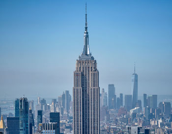 Modern buildings in city against clear sky