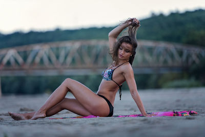 Young woman in bikini while standing in water