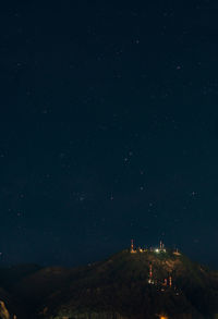 Low angle view of mountain against star field