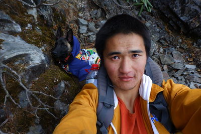 Portrait of smiling mid adult man standing on rock