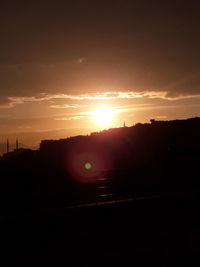 Silhouette landscape against sky during sunset