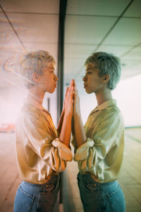 Side view of two boys standing on floor