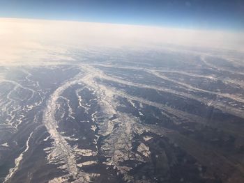 Aerial view of landscape against sky during winter