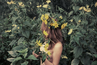 Portrait of woman picking flowers