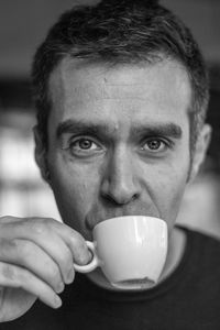 Close-up portrait of man drinking coffee