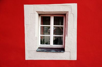 Close-up of window on red wall