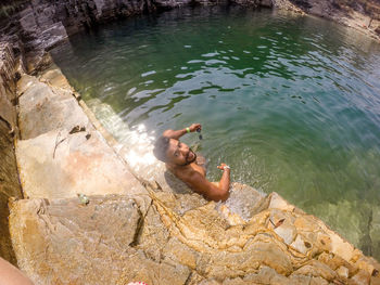 High angle view of shirtless man in lake