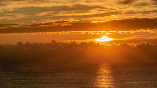 Scenic view of sea against romantic sky at sunset