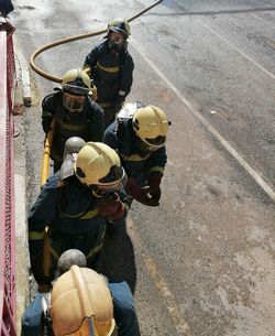 High angle view of firefighters standing on road