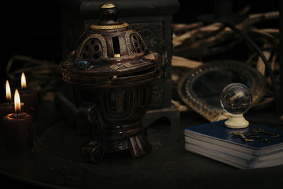 Close-up of illuminated lamp on table