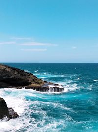 Scenic view of sea against clear blue sky