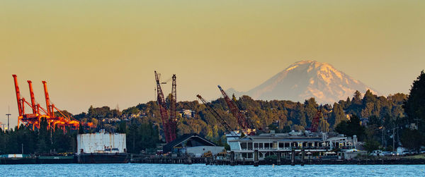Panoramic view of buildings by sea against clear sky