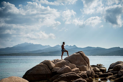 Man standing on mountain against sky