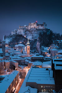 High angle view of illuminated buildings in city at night