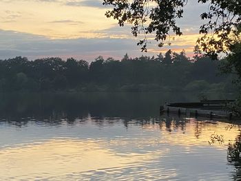 Scenic view of lake against sky at sunset
