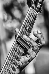 Cropped hand playing guitar