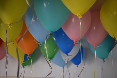 Colorful helium balloons in room