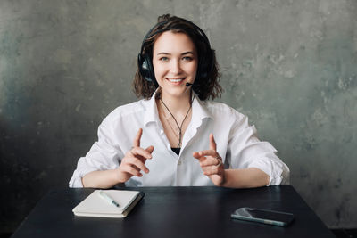 Portrait of young woman using mobile phone