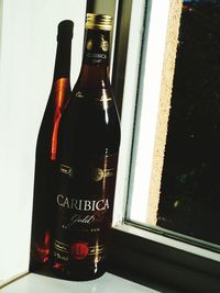 Close-up of wine bottles in glass window