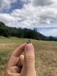 Person holding stone on field