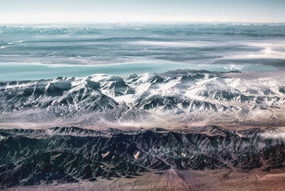 Aerial view of sea and landscape against sky