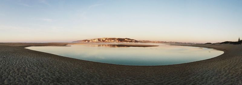 Scenic view of beach against sky during sunset