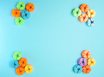 High angle view of multi colored candies against blue background