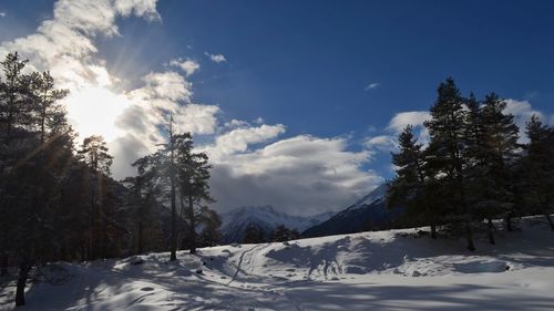 Scenic view of snow covered mountains against sky