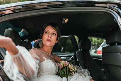 Portrait of woman sitting in car