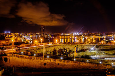 High angle view of illuminated city buildings at night