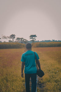 Rear view of man looking at field