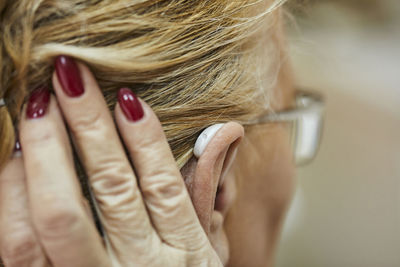 Close-up of senior woman with hearing aid