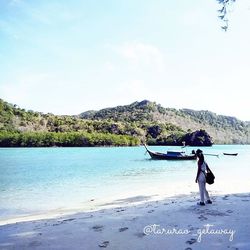 Full length of woman standing on shore