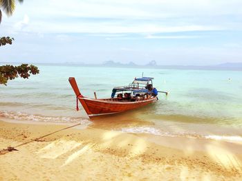 Boats moored at beach