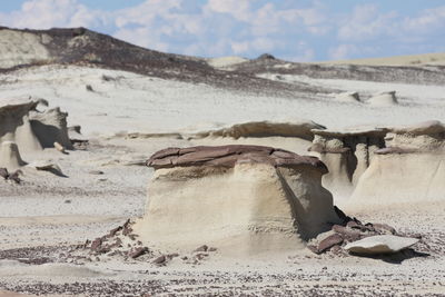 Sand dunes in desert against sky