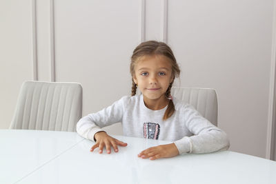 Portrait of a girl sitting on table