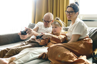 Father and daughter playing game at home