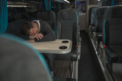 Businessman sleeping in bus