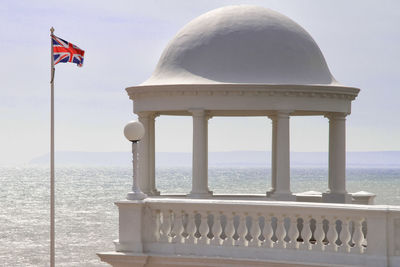 British flag by built structure against sky