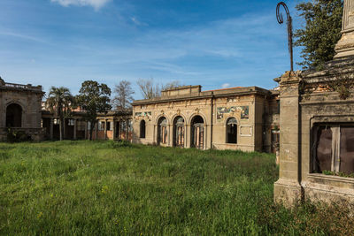 Old building in field against sky