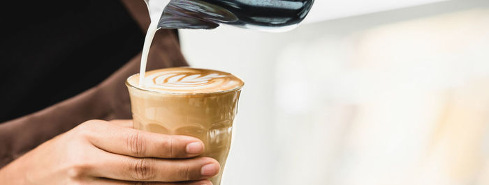 Close-up of hand holding coffee cup