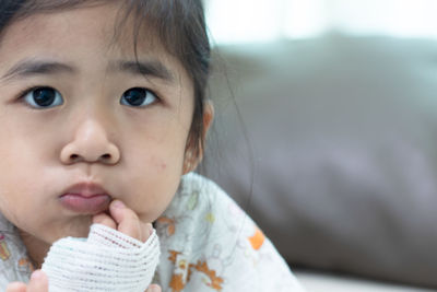 Close-up portrait of cute girl looking away
