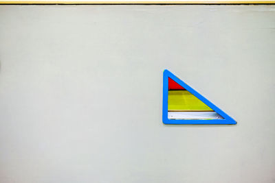 High angle view of multi colored pencils on white wall