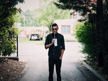 Portrait of handsome man holding on street