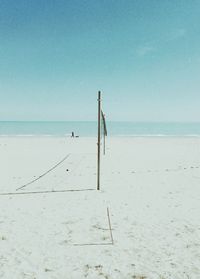 Scenic view of beach against clear blue sky