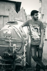 Young man standing against building